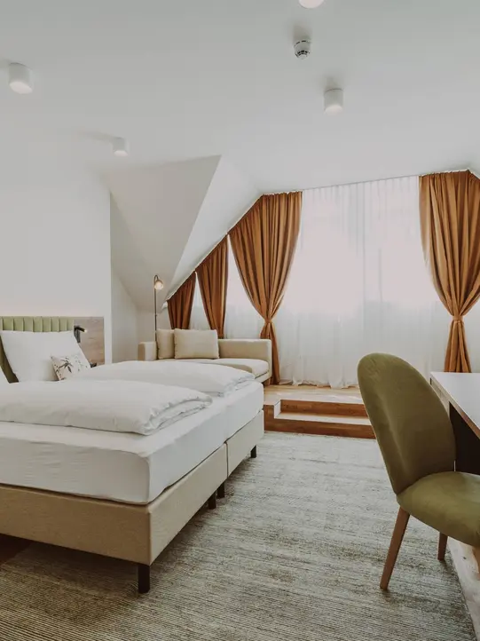 Suite with large bed at Burghotel Schlaining.