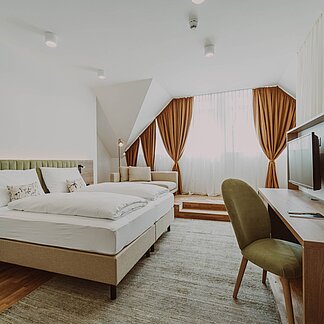 Suite with large bed at Burghotel Schlaining.