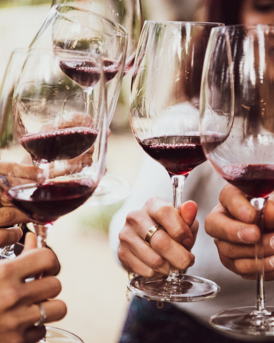 Toasting with red wine glasses