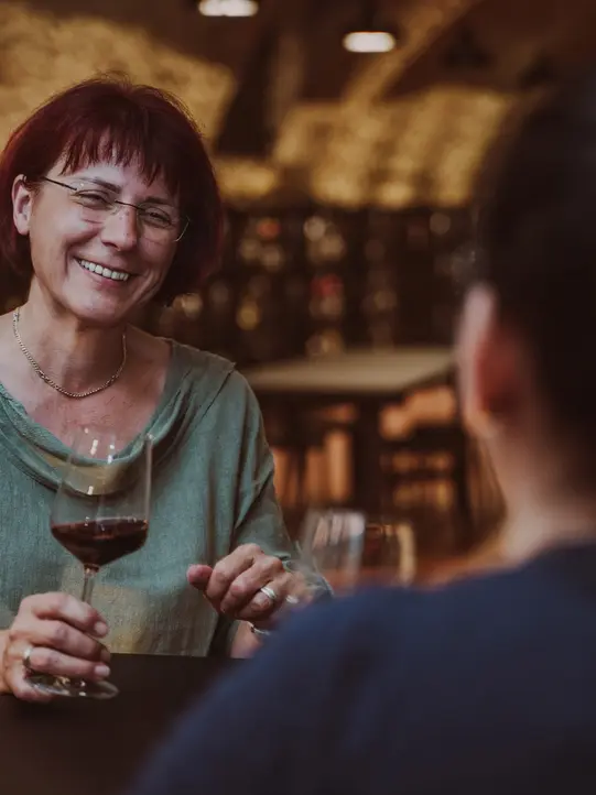 Ladies toast with wine at the Vinothek Burgenland wine tasting room. 