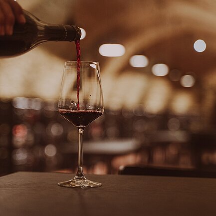 Pouring wine in the Vinothek Burgenland wine tasting room.