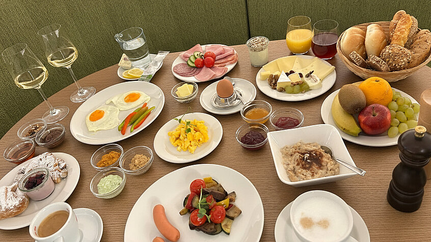 Generously laid breakfast table at Burghotel Schlaining. 