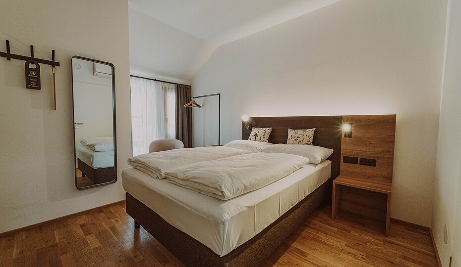 Bed in an Eco double room at the Burghotel Schlaining.