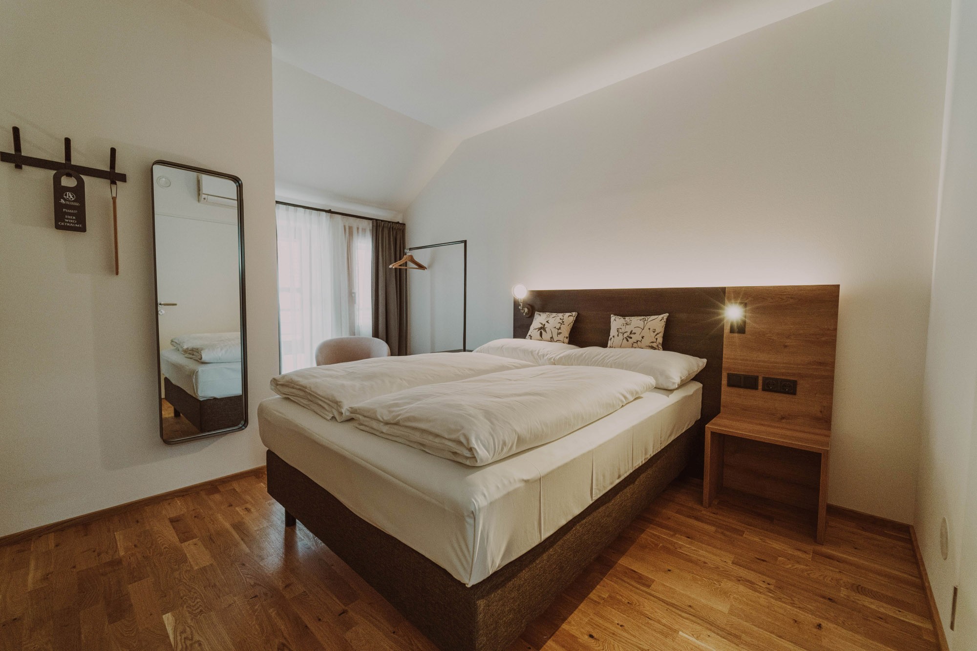 Bed in an Eco double room at the Burghotel Schlaining.